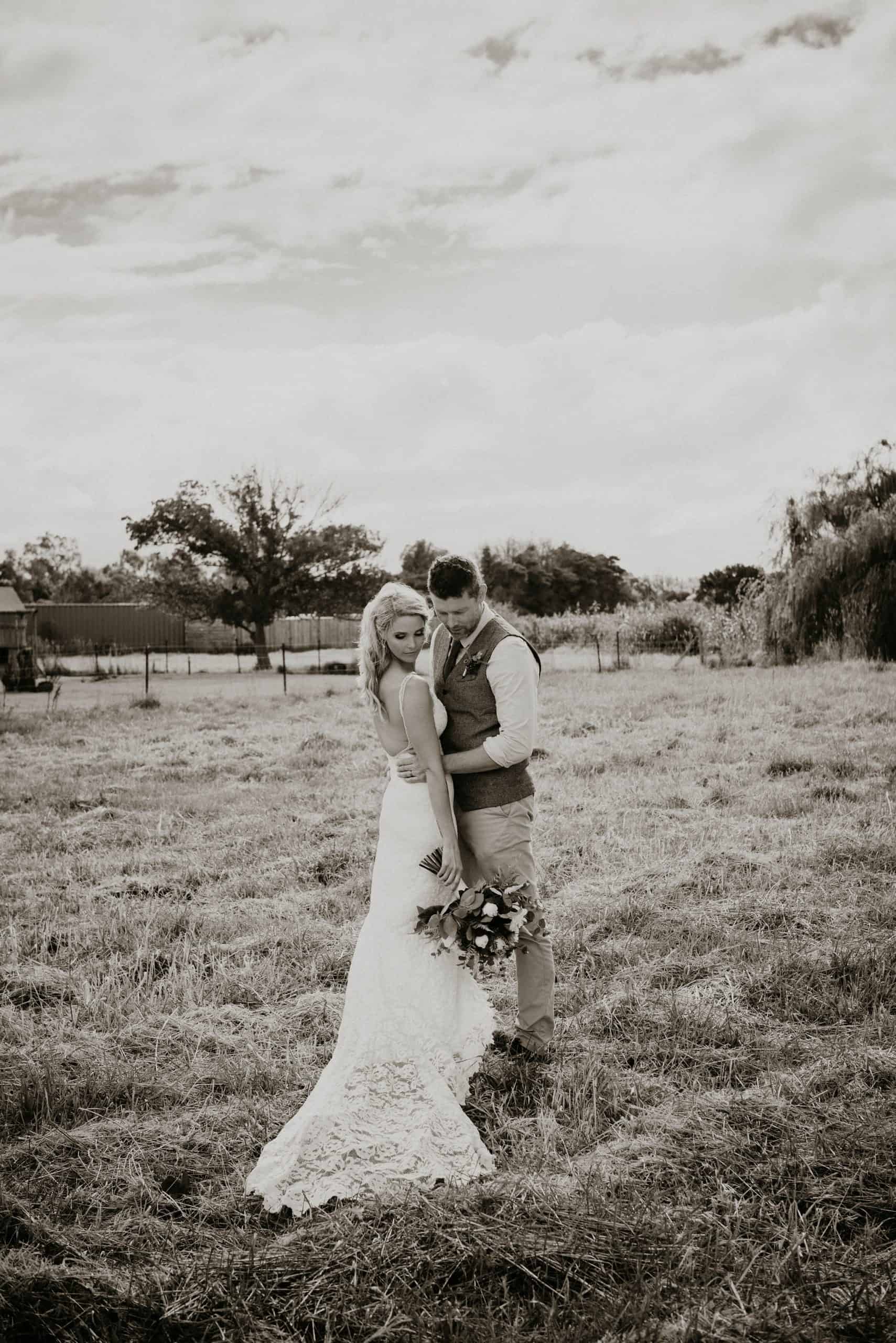 Couple hug in field during elopement photography photo session after their intimate wedding ceremony eloping at home farm property with Let's Elope Melbourne Celebrant Photographer Elopement Package Victoria Sarah Matler Photography