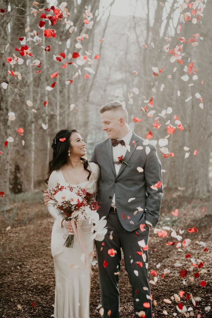 Couple stands under thrown rose petals plane tree walk how to elope Intimate Wedding Melbourne Lets Elope Melbourne Celebrant Photographer Elopement Package Victoria Sarah Matler Photography Fitzroy Garden weddings intimate