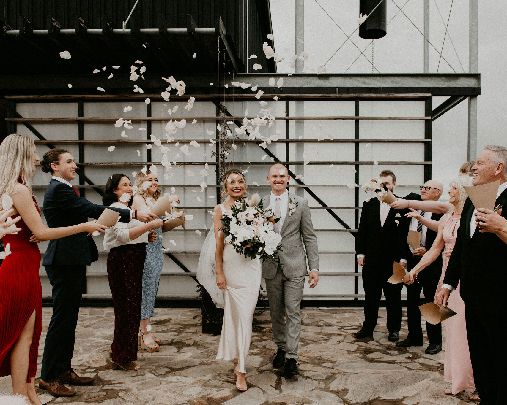Zonzo Estate Elopement bride and groom exit guests throw rose petals in the air Lets Elope Melbourne Celebrant Photography Elopement Package Victoria Sarah Matler Photography Yarra Valley Winery intimate Wedding Photos