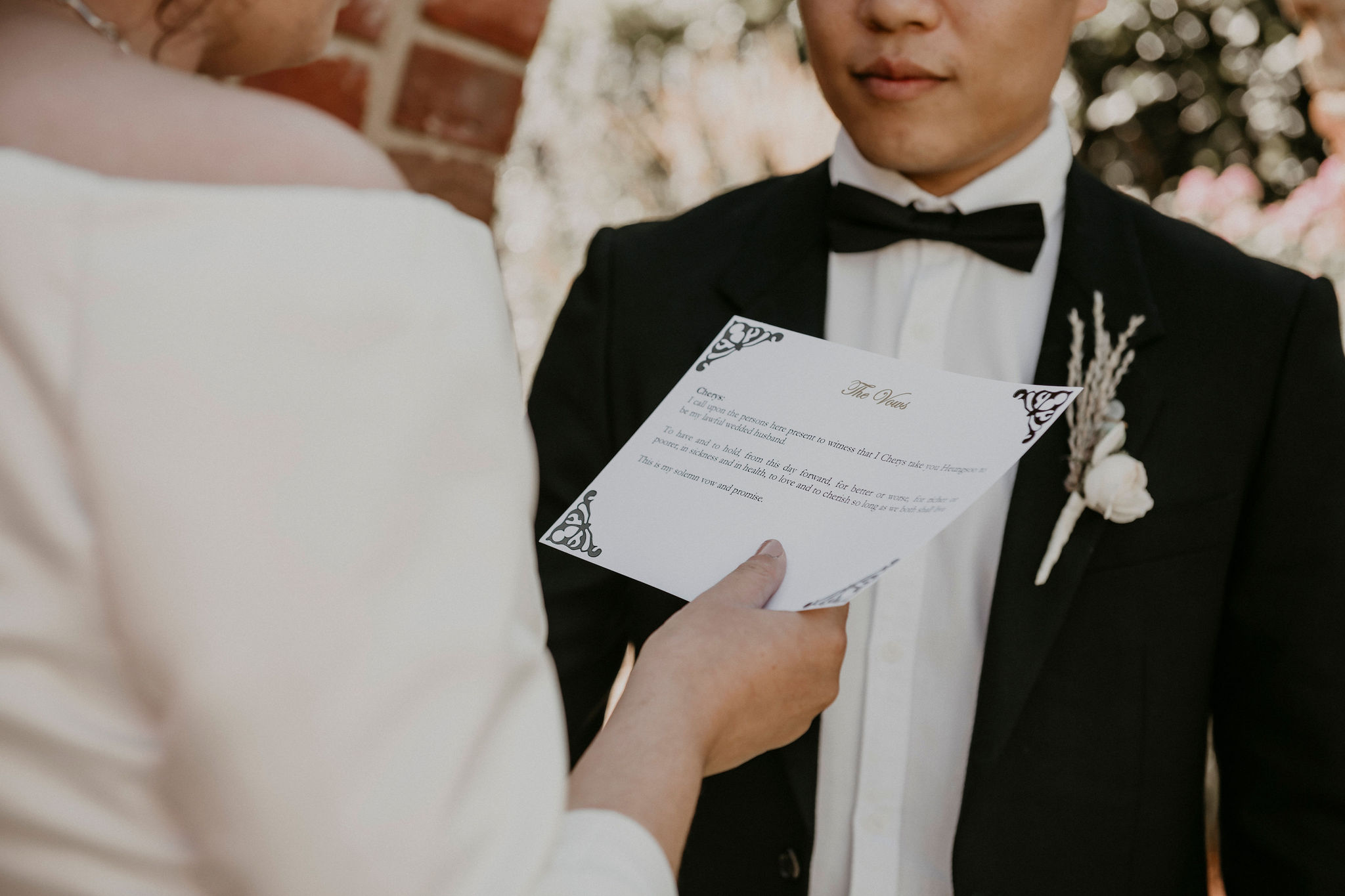 Ceremony takes place by the brick folly close up of brides vows Let's Elope Melbourne Portfolio Celebrant Photographer Elopement Packages Victoria Sarah Matler Photography intimate weddings Acre of Roses Trentham romantic ceremony