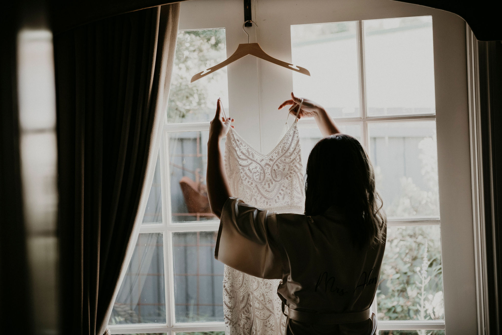 Bride prepares wedding dress before ceremony getting ready by the window light Let's Elope Melbourne Portfolio Celebrant Photographer Elopement Packages Victoria Sarah Matler Photography intimate weddings Acre of Roses Trentham romantic ceremony